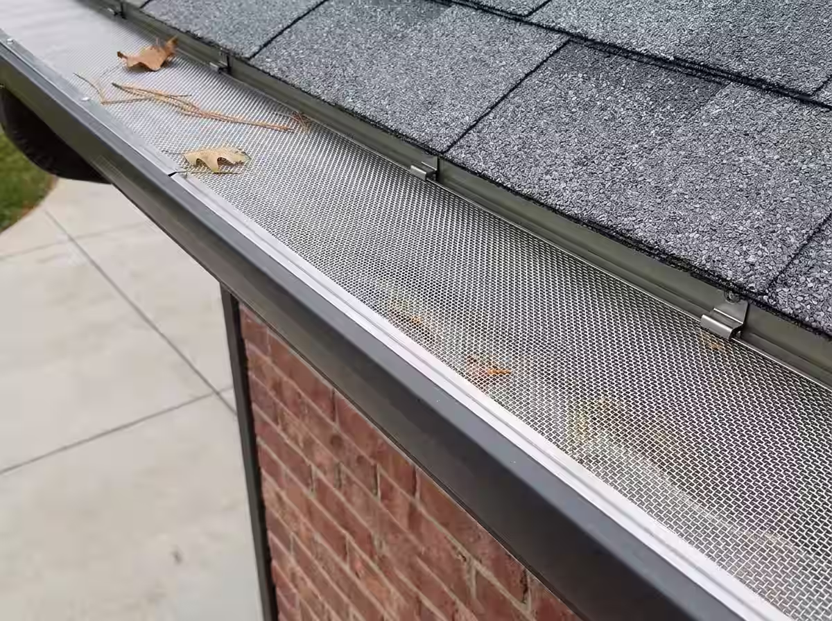 Gutter guard mesh being custom-fitted and installed on a Gauteng property